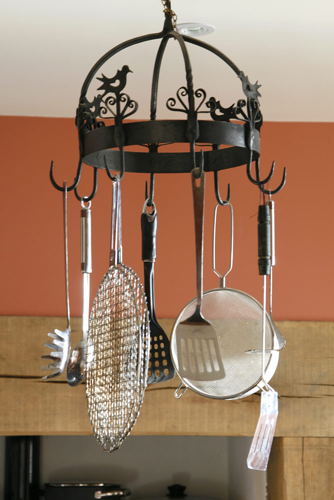 Kitchen Utensils hanging from an ornate metal display