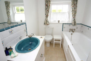 A light and airy bathroom with toilet, sink and bath
