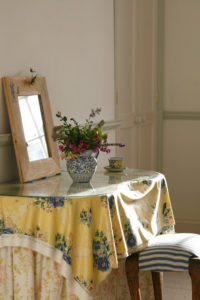 Fresh Flowers in front of a mirror on a dressing table