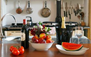 Porthcothan House Kitchen worktop with wine and fruit