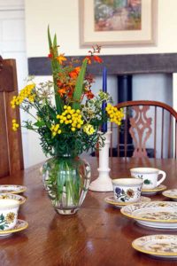 Bright flowers in vase on a dining table