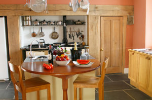 Rustic Georgian farmhouse Kitchen with Aga and warm orange walls