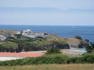 The stunning coastal view from Porthcothan House with sandy beach and bright green cliffs
