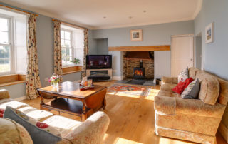 Light and spacious sitting room with cosy fireplace