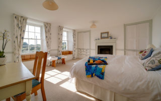 A light and spacious bedroom with twin beds and a dressing table