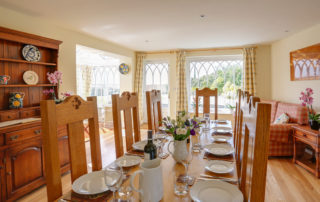 Spacious and light dining room with wooden floors dining table and chairs