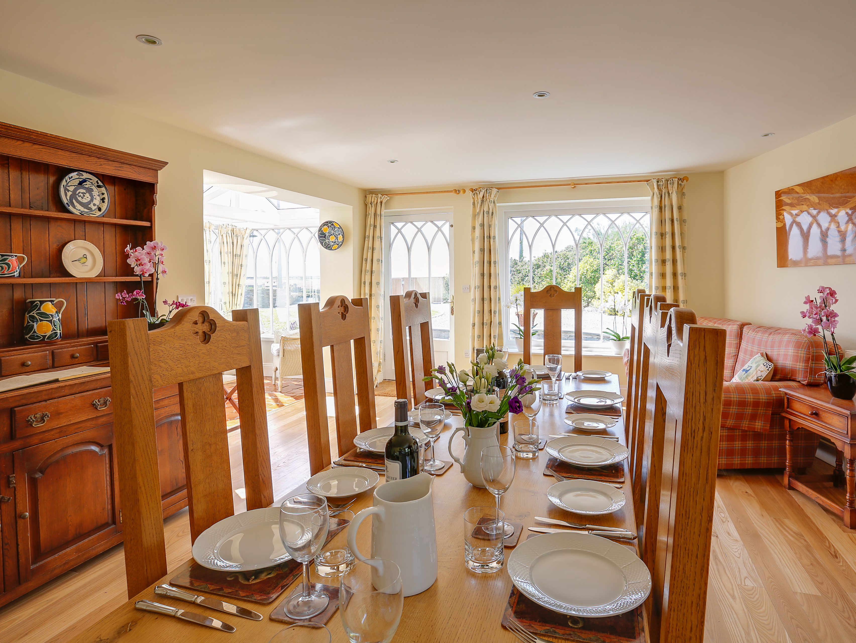 Spacious and light dining room with wooden floors dining table and chairs