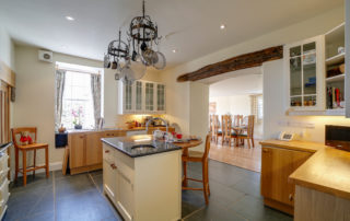 Light and spacious Kitchen with stone floors and cooking island
