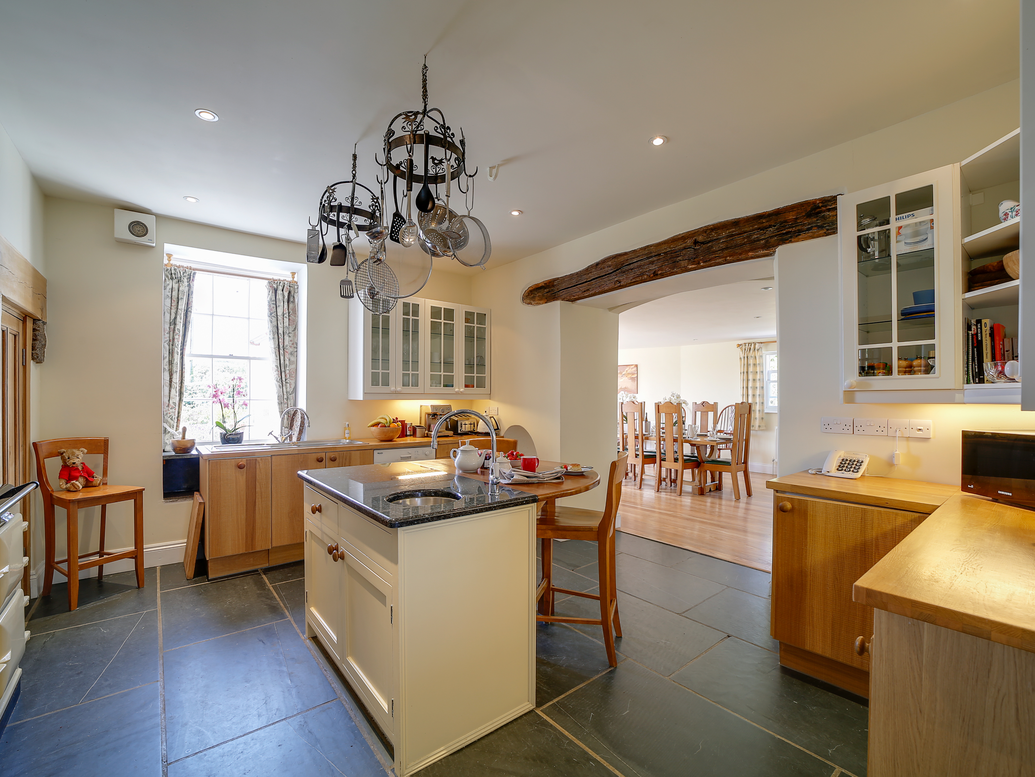 Light and spacious Kitchen with stone floors and cooking island